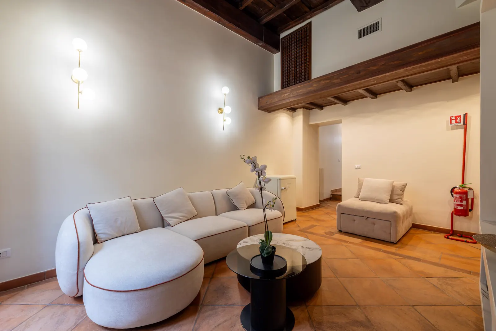 Area living con soffitto in legno e sedute chiare